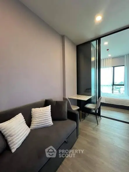 Modern apartment interior with cozy living area and stylish bedroom view.