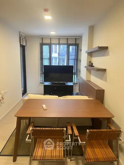 Modern living room with stylish furniture and large window view, perfect for cozy urban living.