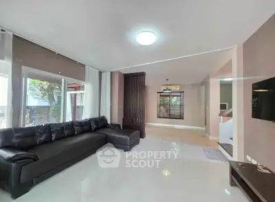 Spacious modern living room with sleek design and large windows for natural light.