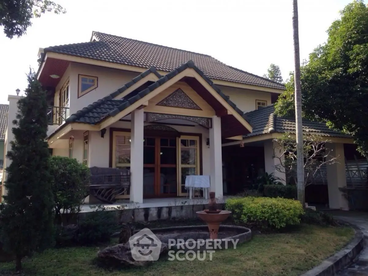 Charming two-story house with lush garden and traditional architectural details