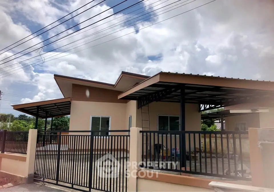 Modern single-story home with sleek metal roofing and spacious driveway