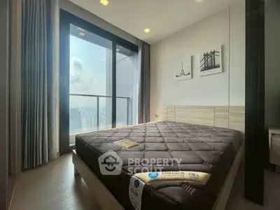 Modern bedroom with large window and city view, featuring stylish decor and natural light.