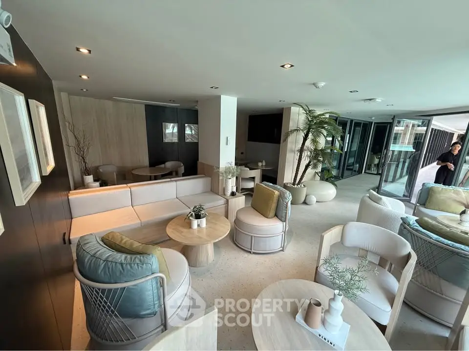 Luxurious modern living room with elegant decor and large windows offering natural light.