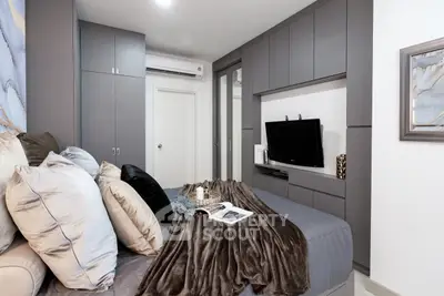 Modern bedroom with sleek gray cabinetry and cozy bedding