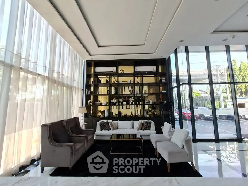Luxurious modern lobby with elegant seating and floor-to-ceiling windows.