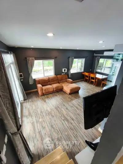 Spacious living room with modern decor and large windows for natural light