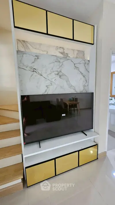 Modern living room with stylish TV unit and marble accent wall