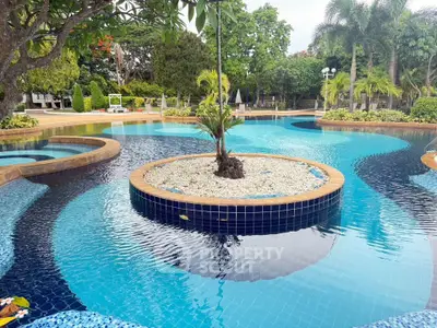 Luxurious outdoor pool with lush greenery and serene ambiance in a tropical setting.