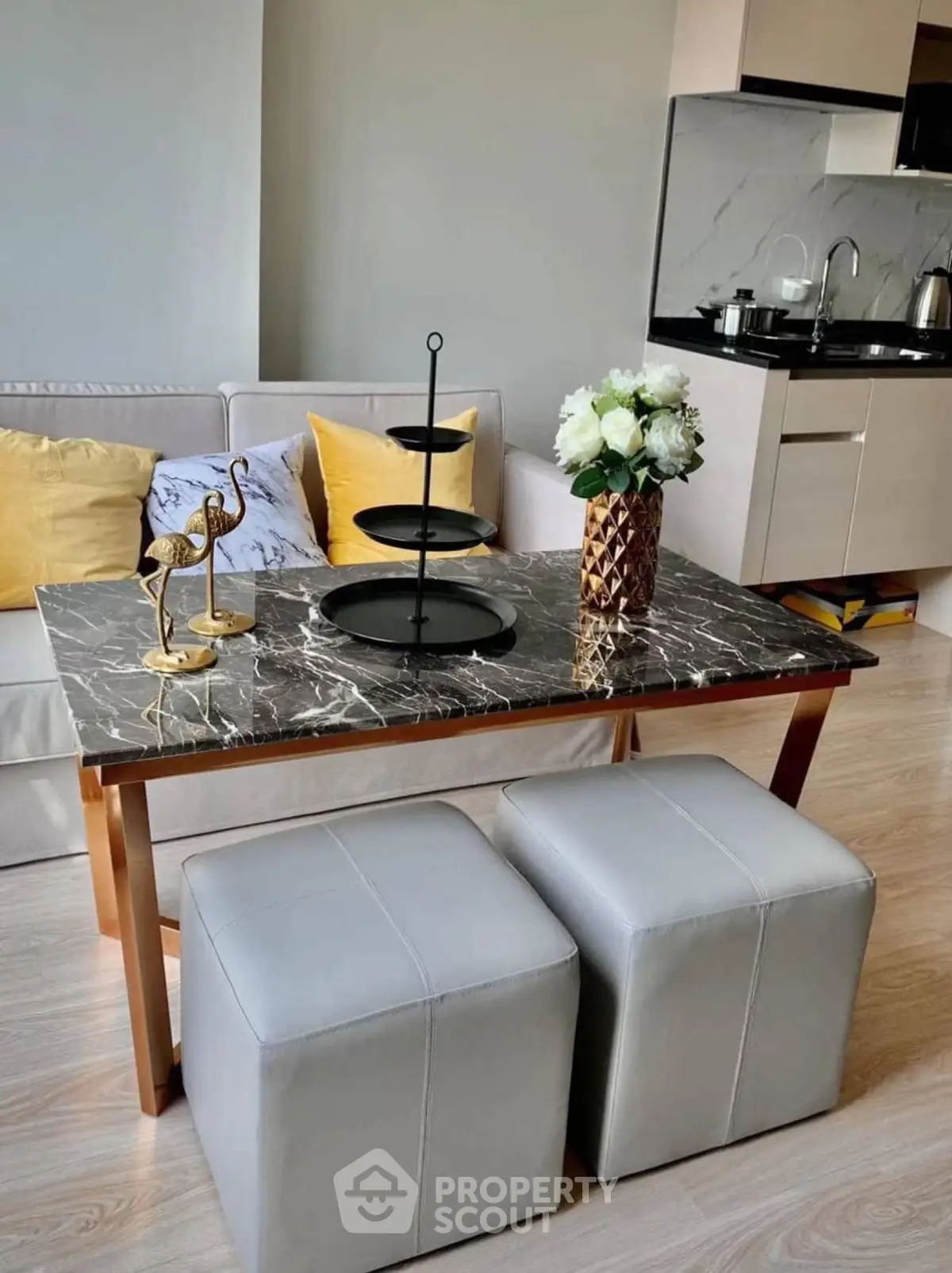 Modern living room with elegant marble table and cozy seating in stylish apartment.