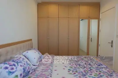 Cozy bedroom with floral bedding and ample closet space