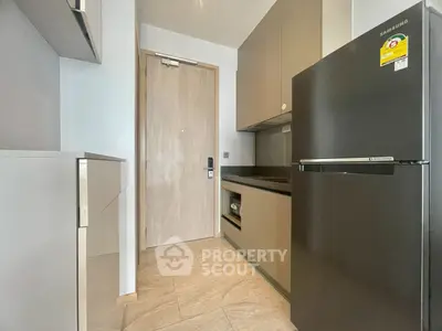 Modern kitchen with sleek appliances and minimalist design in a contemporary apartment.