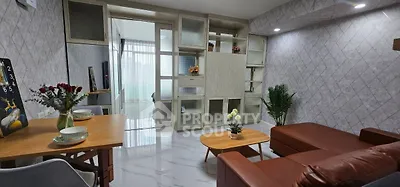 Modern living room with stylish furniture and open layout, featuring a cozy seating area and elegant decor.