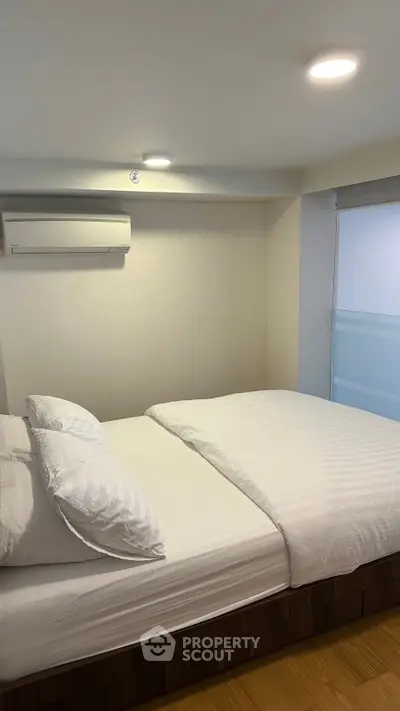 Cozy bedroom with modern air conditioning and natural light