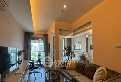 Modern living room with city view, stylish furniture, and workspace in a high-rise apartment.