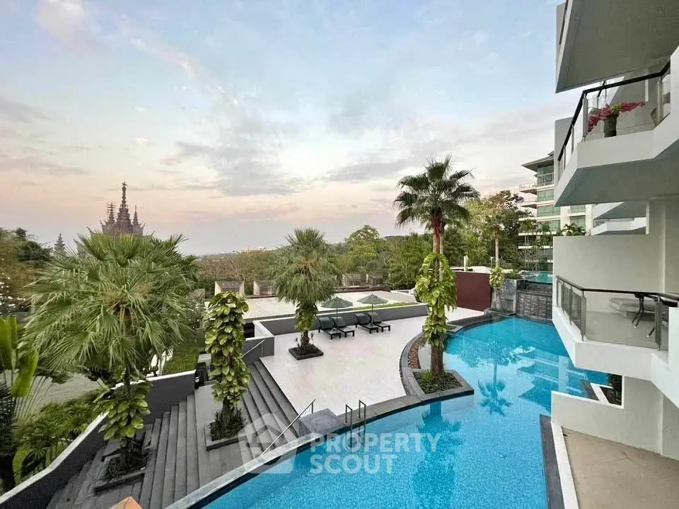 Luxurious poolside view with modern architecture and lush greenery