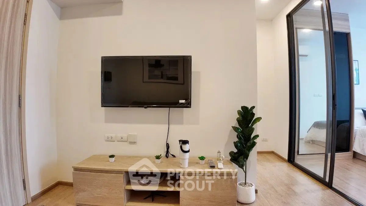 Modern living room with wall-mounted TV and sleek wooden furniture