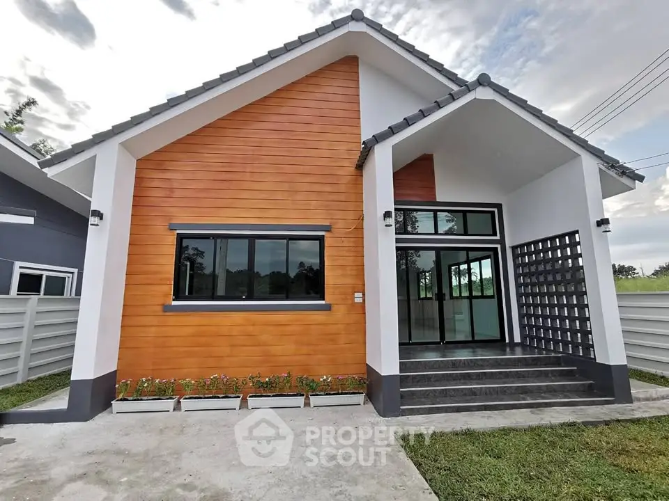 Modern single-story house with wooden facade and large windows