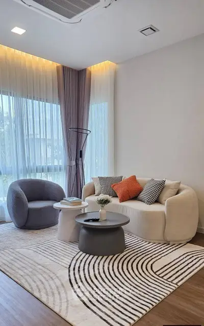 Modern living room with stylish furniture and large windows for natural light