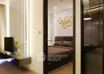 Modern bedroom with stylish decor and open layout, featuring elegant lighting and contemporary furnishings.