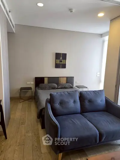 Modern studio apartment with cozy bed and stylish sofa