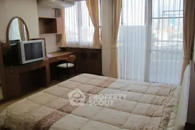 Cozy bedroom with large window and classic wooden furniture