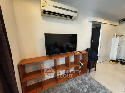 Modern living room with air conditioning and TV on wooden shelf