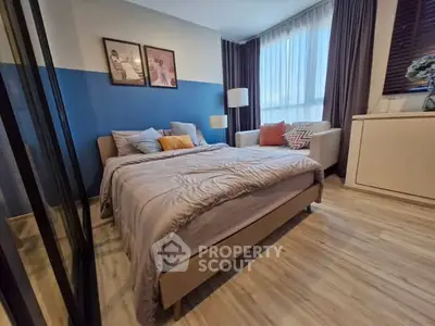 Cozy bedroom with modern decor and large windows for natural light.