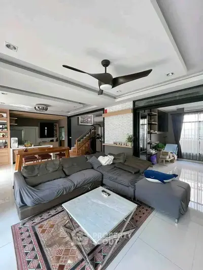Spacious modern living room with stylish decor and open kitchen layout