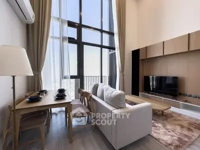 Spacious modern living room with high ceilings and large windows