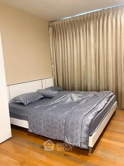 Modern bedroom with elegant gray bedding and floor-to-ceiling curtains