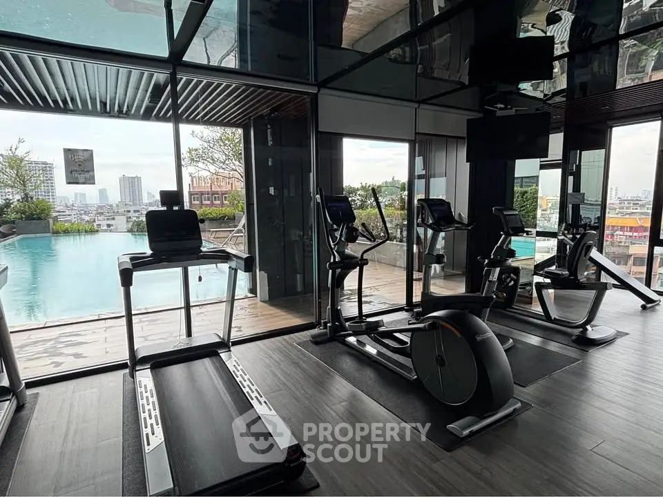 Modern gym with pool view in luxury apartment complex