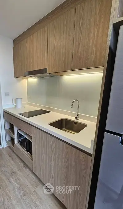 Modern kitchen with sleek wooden cabinets and stainless steel appliances
