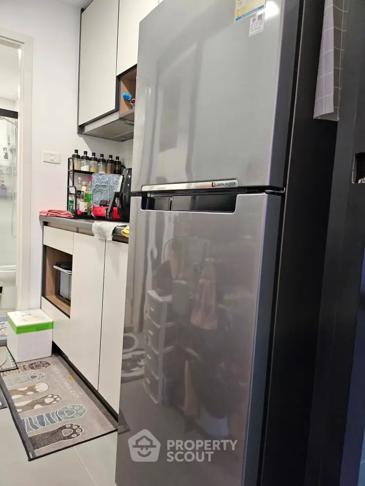 Modern kitchen with sleek refrigerator and organized storage space