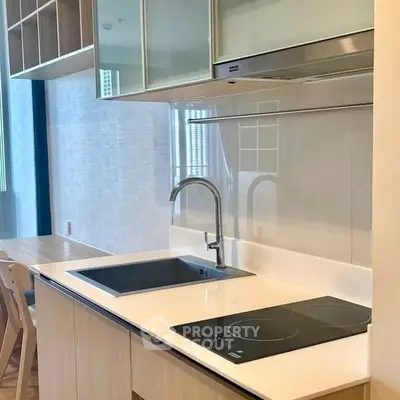 Modern kitchen with sleek cabinetry and induction cooktop