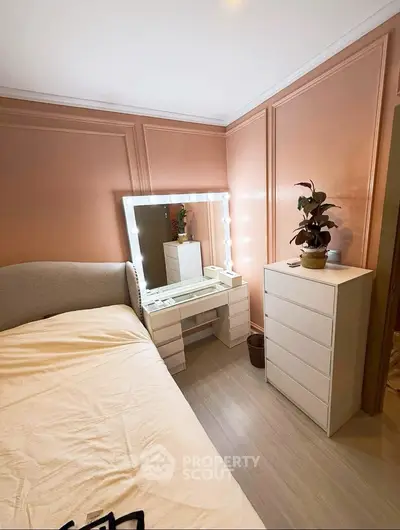 Charming bedroom with elegant vanity and soft lighting, perfect for relaxation and style.