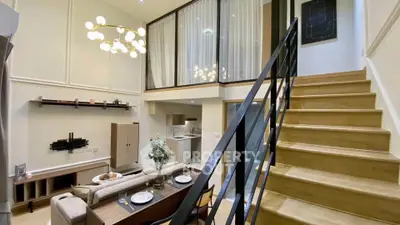 Modern duplex apartment with stylish open layout and elegant staircase