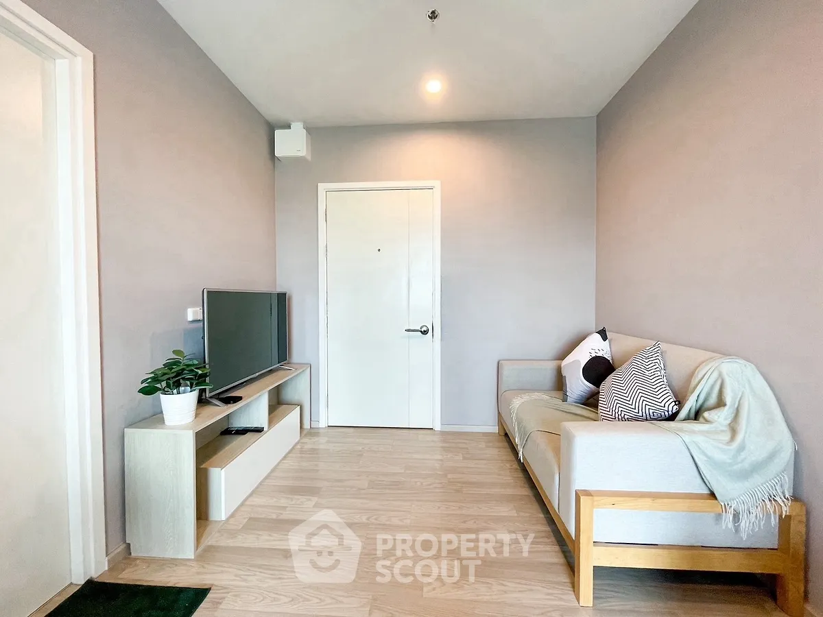 Modern living room with cozy sofa and TV unit, perfect for relaxation.