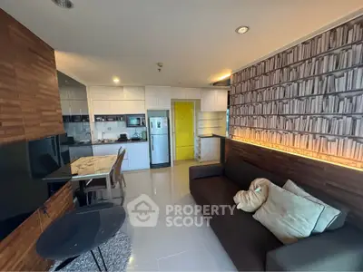 Modern living room with stylish decor and open kitchen layout in a contemporary apartment.