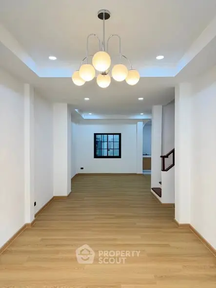 Spacious modern living room with elegant lighting and wooden flooring