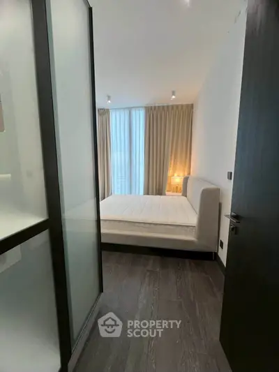 Modern bedroom with floor-to-ceiling windows and elegant decor