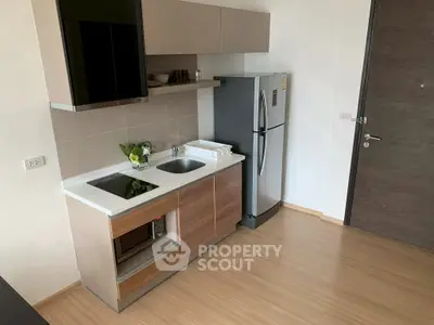 Modern compact kitchen with sleek appliances and minimalist design