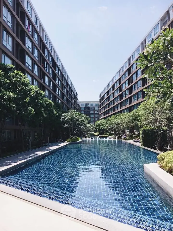 Luxurious apartment complex with a stunning outdoor pool and lush greenery, perfect for relaxation and leisure.