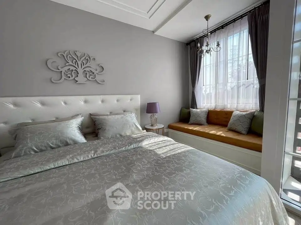 Elegant bedroom with cozy window seating and stylish decor