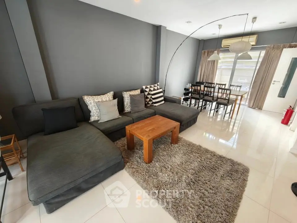 Spacious living room with modern decor and large sectional sofa in a stylish home.