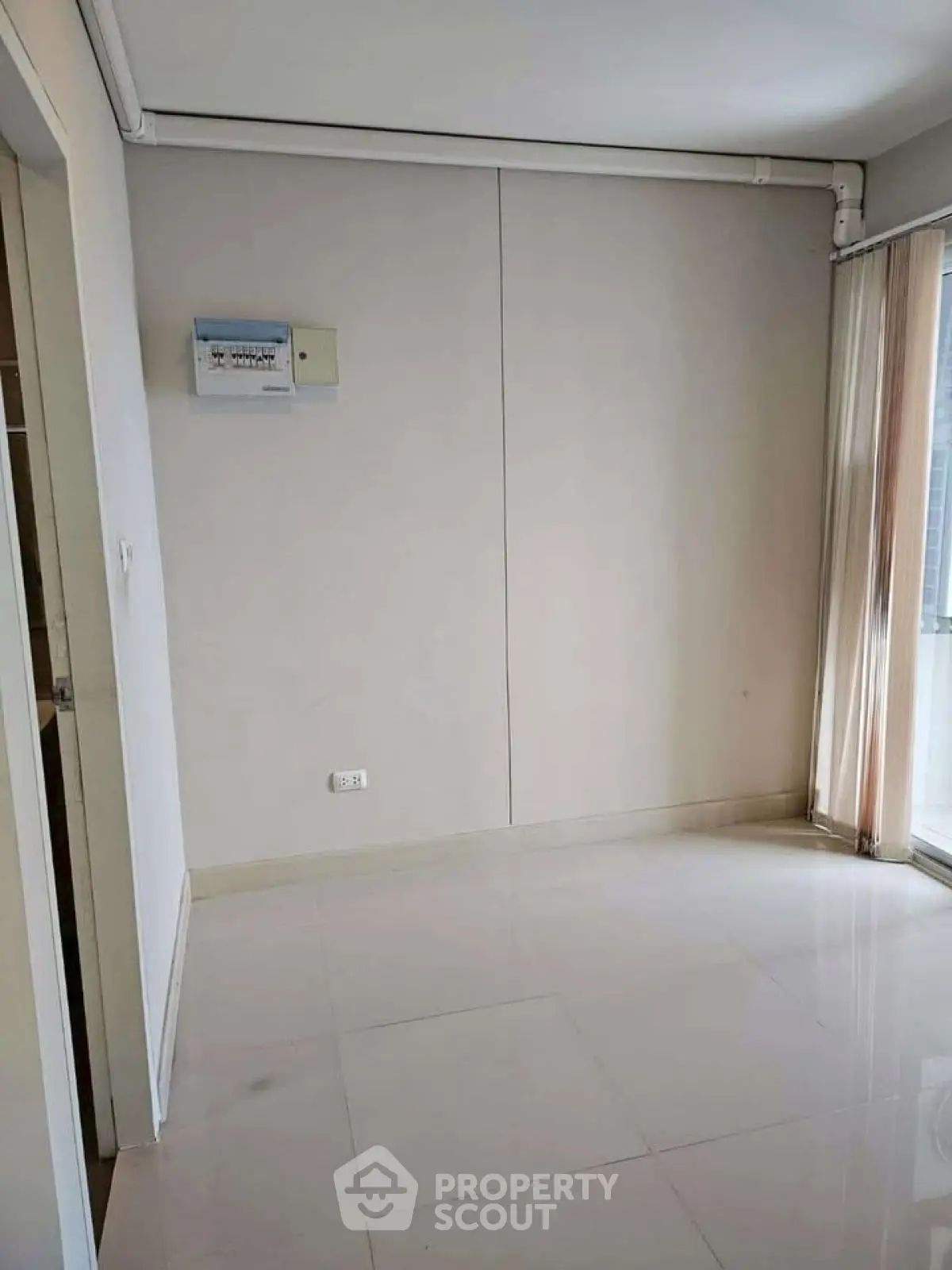 Spacious empty room with large windows and glossy tiled floor, perfect for customization.