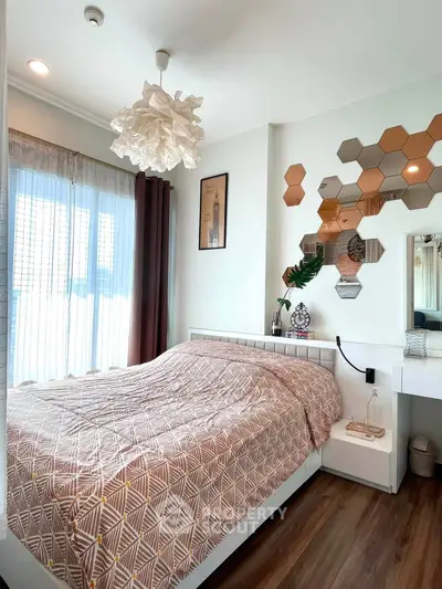 Cozy bedroom with modern decor and ample natural light from large windows.