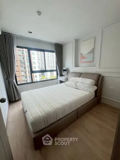 Modern bedroom with large window and stylish decor in urban apartment