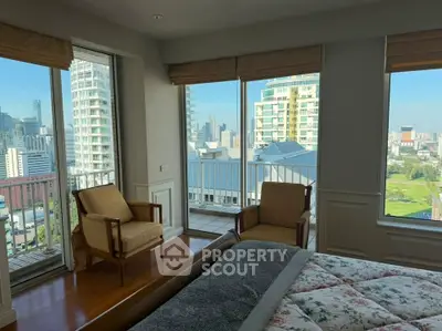 Spacious bedroom with stunning city view and private balcony access