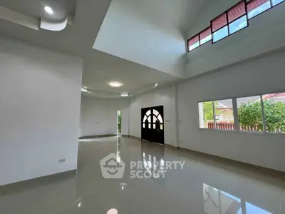 Spacious modern living room with high ceilings and large windows