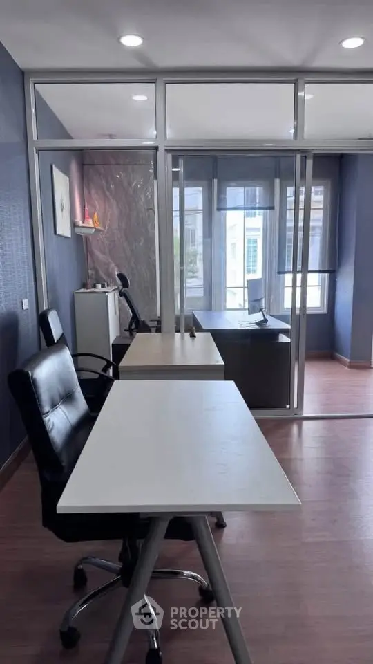 Modern office space with glass partitions and sleek furniture